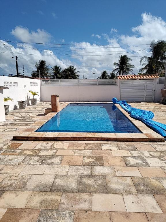 卢塞纳Bela casa de Veraneio - faça sua reserva.的庭院中带滑梯的游泳池