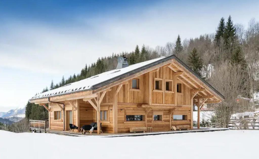 Arâches-la-FrasseCoco Chalet的大型小木屋,设有雪盖屋顶