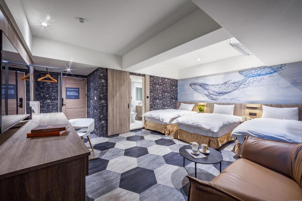 台中市墨鐵會館的酒店客房,设有两张床和一张沙发