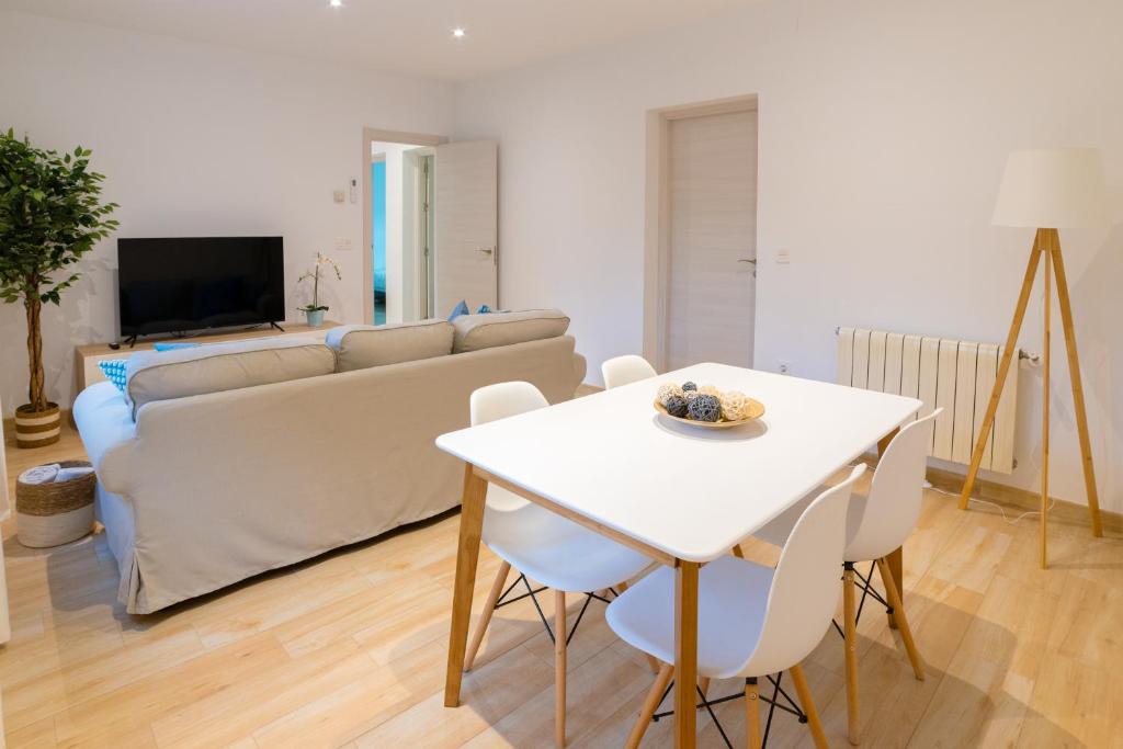 格拉纳达TrendyHomes Granada - moderno apartamento a 15 minutos del centro的客厅配有白色桌子和沙发