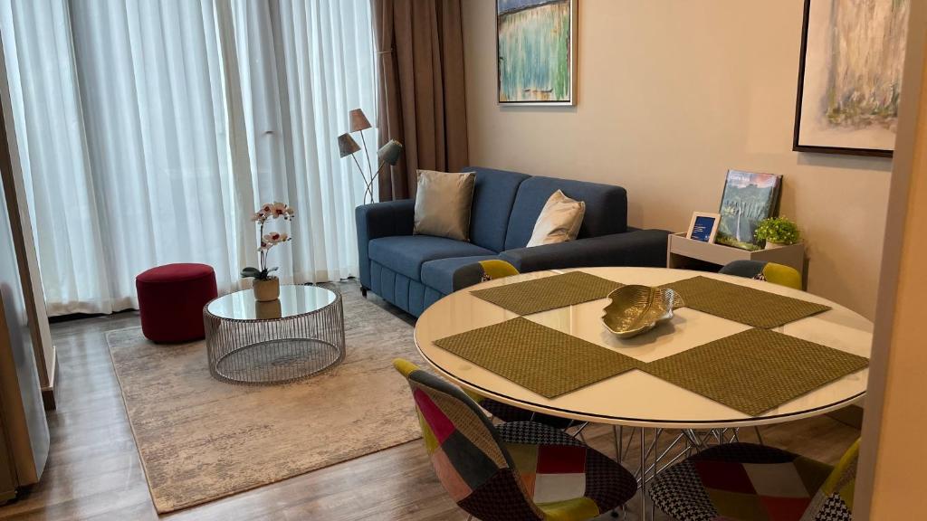 圣何塞Cozy apartment with terrace, SJ Cosmopolitan Tower的客厅配有桌子和蓝色沙发