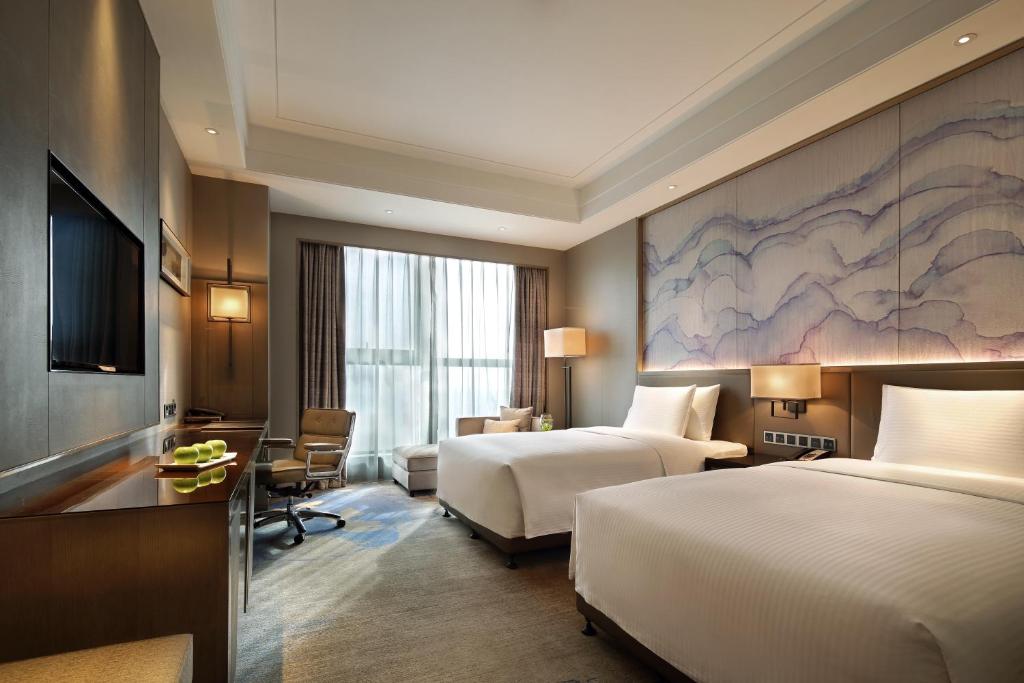 黄石黄石富力万达嘉华酒店的酒店客房配有两张床和一张书桌
