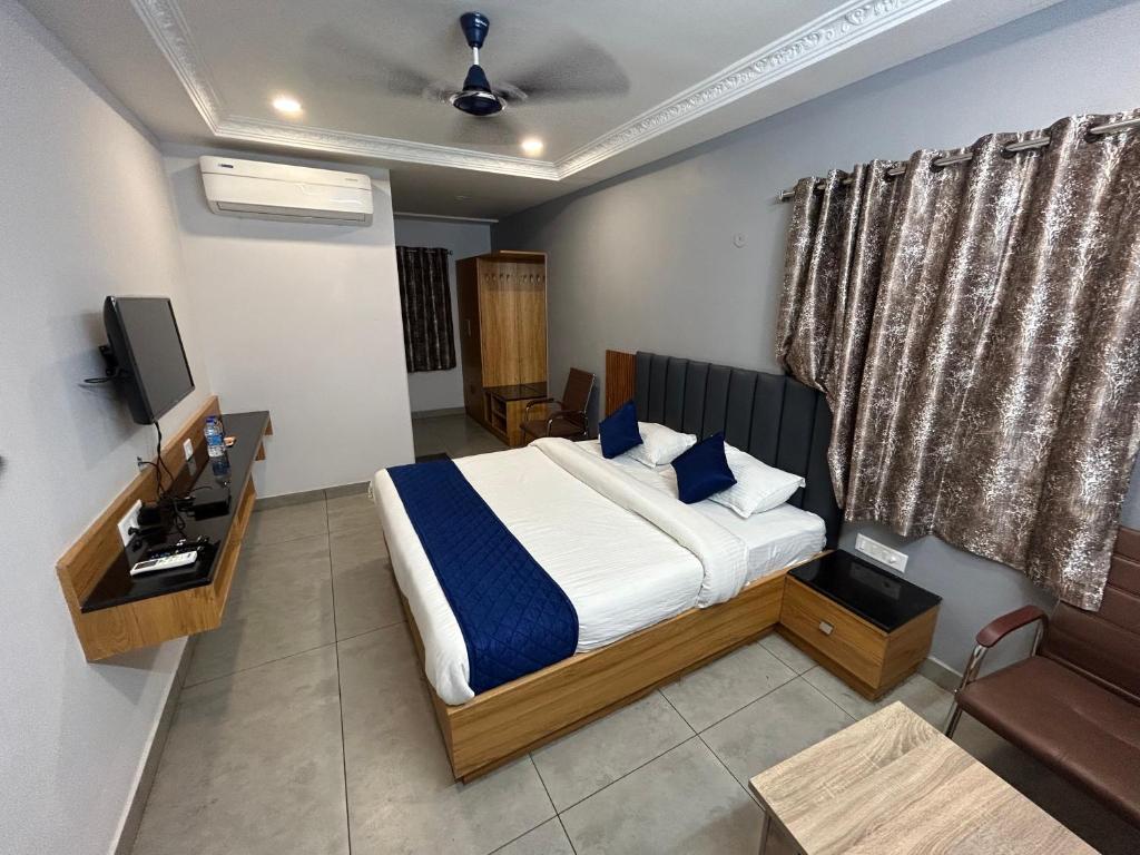 卡努尔KKM Highlands的一间卧室配有一张床和一台电视