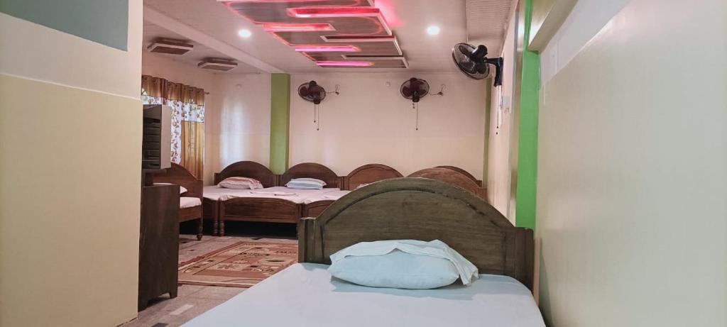 拉塔古里Hotel Sonali的带一张床的房间和一间带两张床的房间