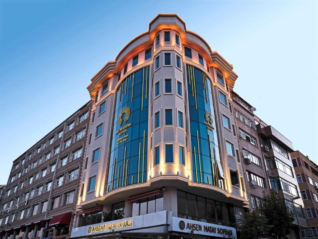 伊斯坦布尔All Seasons Suites的一座高大的建筑,外墙橙色和蓝色