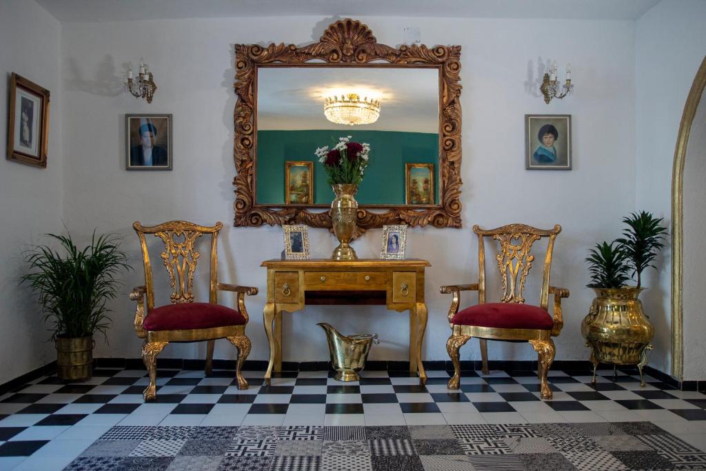 阿特利斯科Casa Zepeda的配有桌子、两把椅子和镜子的房间