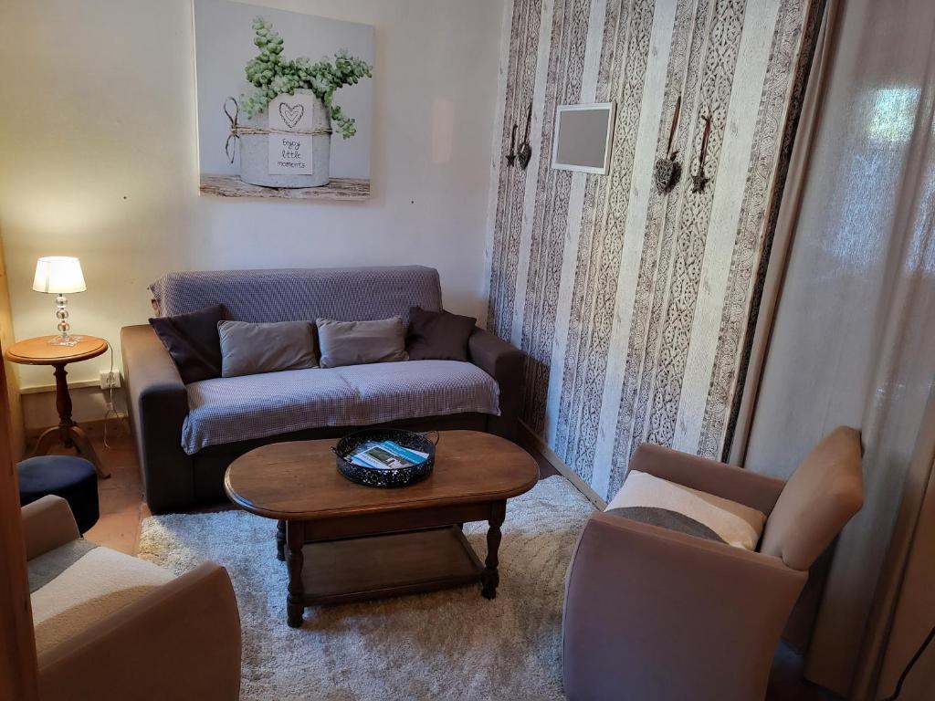 Gréez-sur-RocLa Gouline的客厅配有沙发和桌子