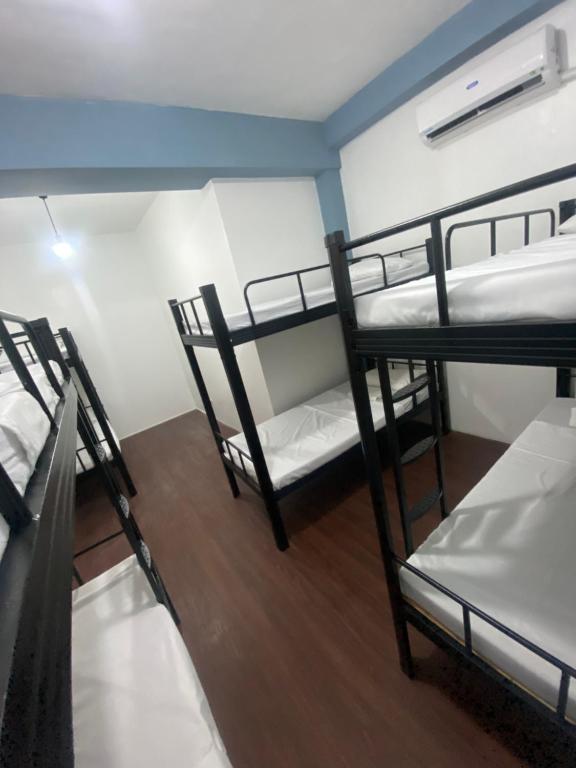 马尼拉Lime Lite Manila Hostel的宿舍间内的3张双层床