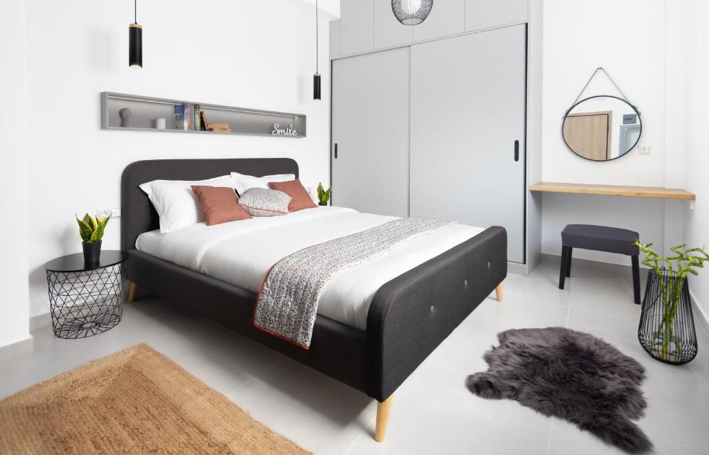 雅典Ando’s Cozy Studio Apartment的一间卧室配有床、镜子和地毯