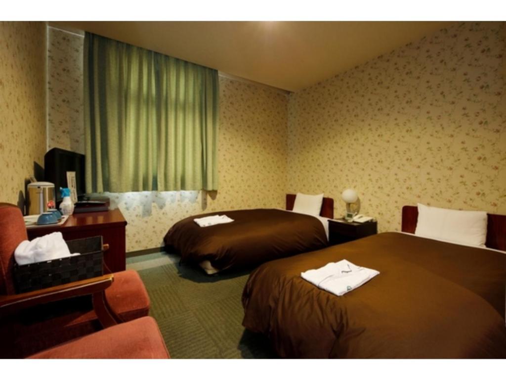 ZentsujiZentsuji Grand Hotel - Vacation STAY 16635v的酒店客房,配有两张床和椅子