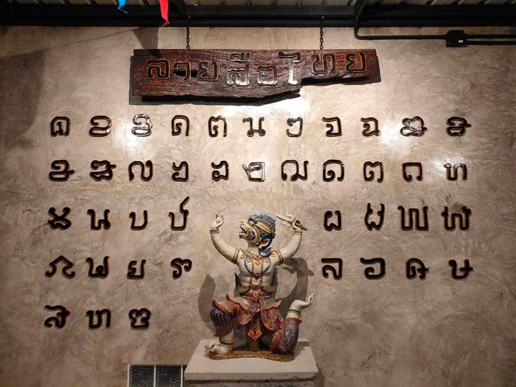 素可泰笑脸旅馆的墙上有字母的女人的雕塑