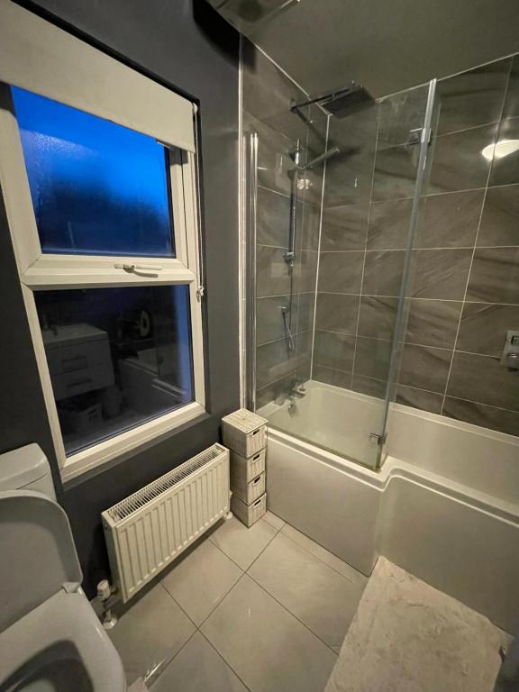波特斯巴Single Room in Potters Bar Hertfordshire的带淋浴和卫生间的浴室以及窗户。