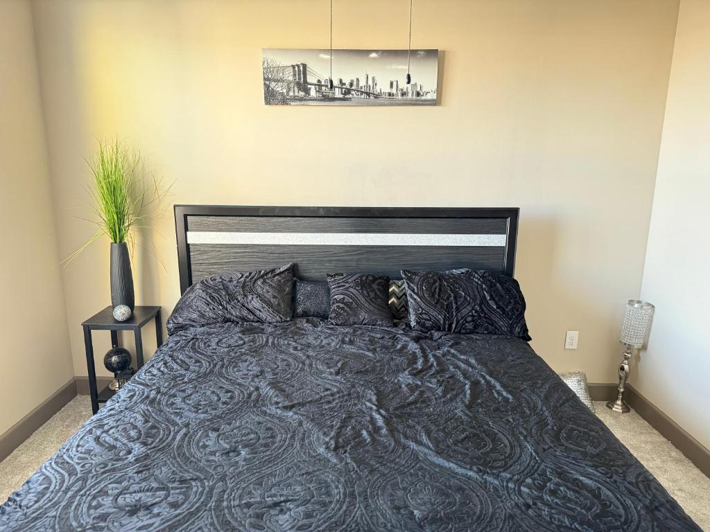 艾迪生Luxury Apartment in Dallas的一间卧室配有一张大床和黑色床头板