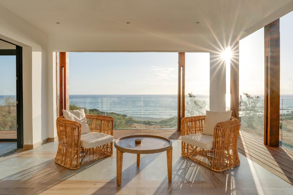 Trois BassinsLe Moma by the ocean的海景客房 - 带椅子和桌子