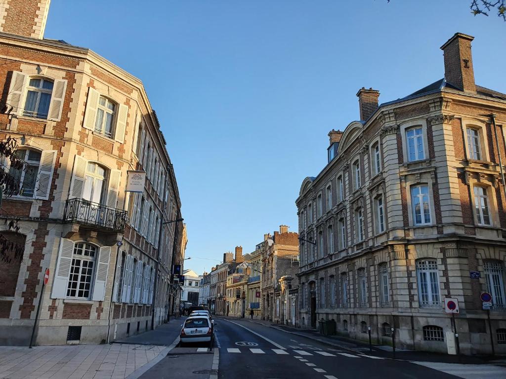 亚眠Hôtel Spa Marotte的街道上拥有建筑和汽车的城市街道