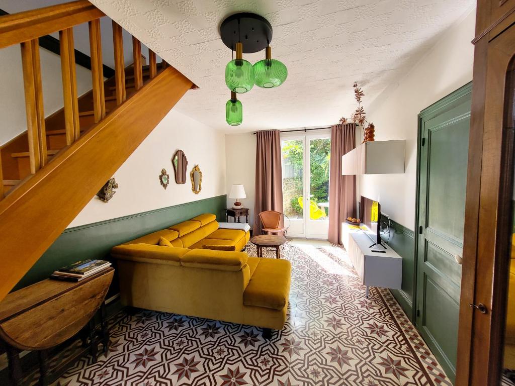 昂热Guest House "Près des Montgolfières"的客厅设有黄色沙发和楼梯。
