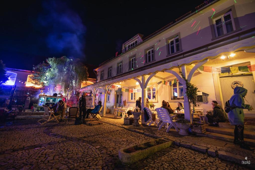 WleńTurkusowa Wyspa的一群人晚上坐在建筑物外面