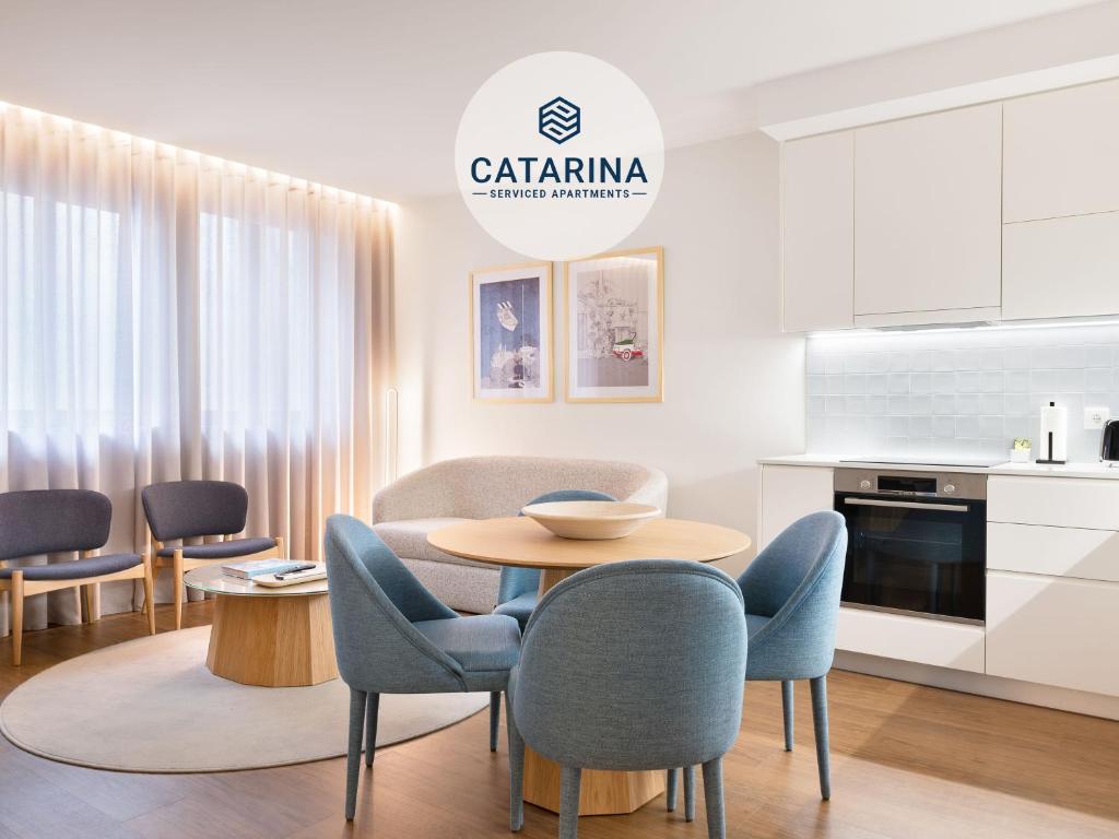 波尔图Catarina Serviced Apartments的厨房以及带桌椅的用餐室。