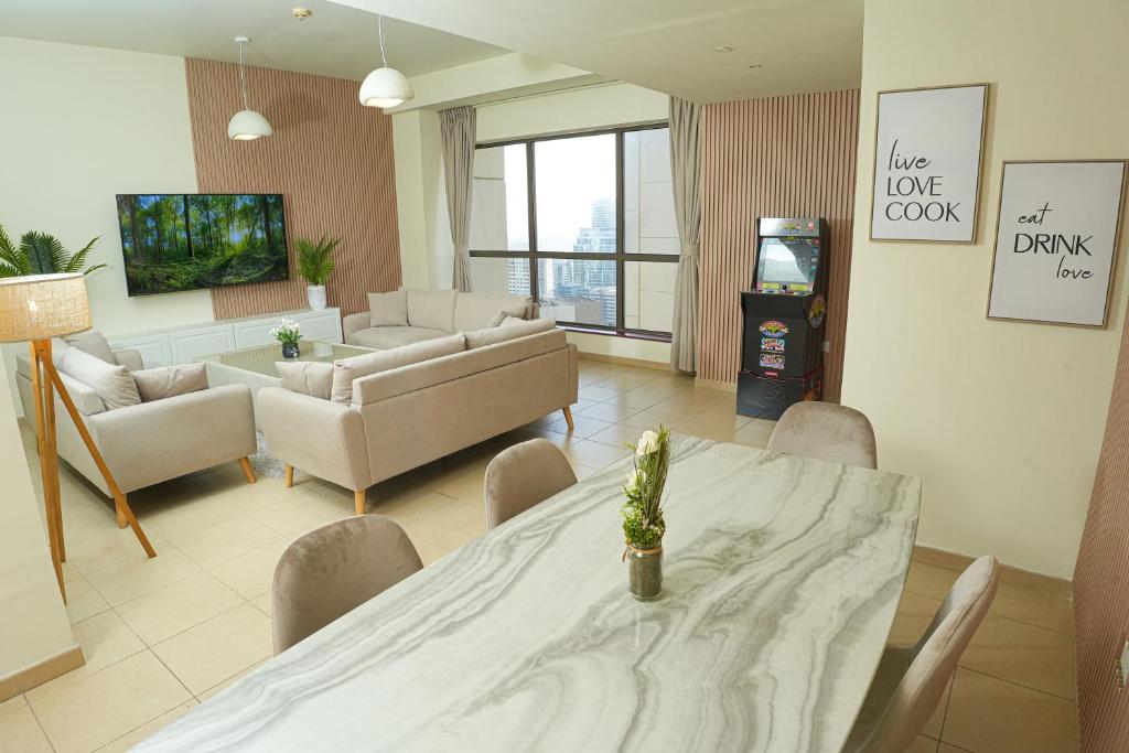 迪拜Pure Sand - Luxury Hostel JBR Dubai的客厅配有桌椅和沙发