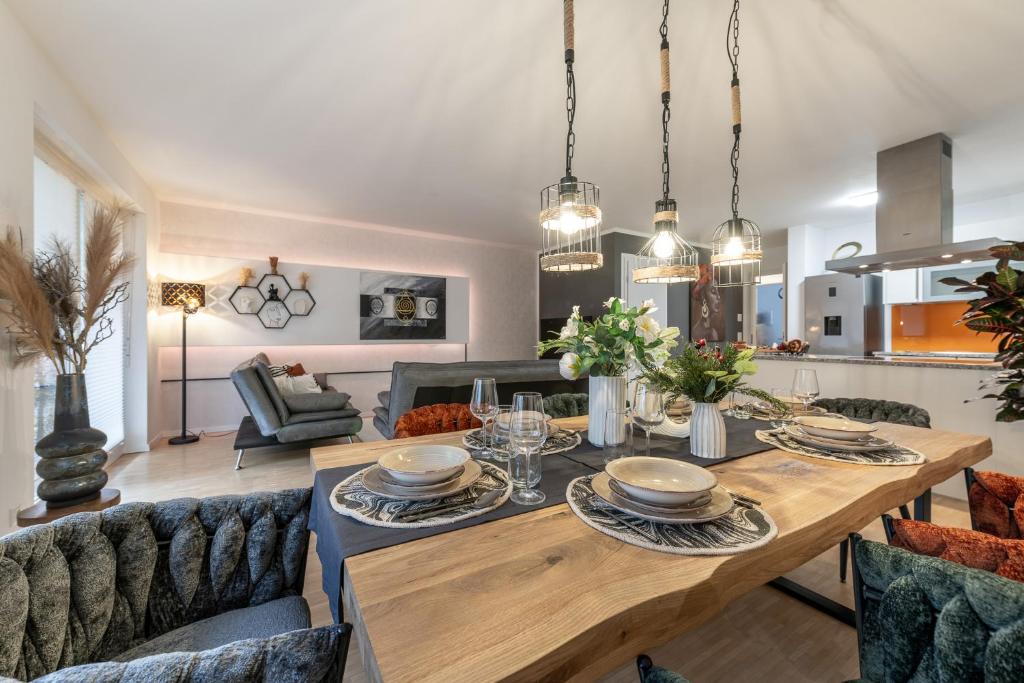 彭茨贝格Alpenflair / Luxury / 100qm / Work / Travel / Netflix的用餐室以及带桌椅的起居室。