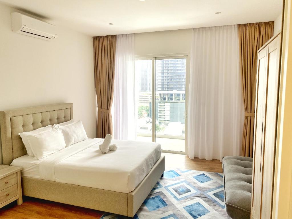 吉隆坡Lila Suites Quill Residences Klcc的一间卧室设有一张床和一个大窗户