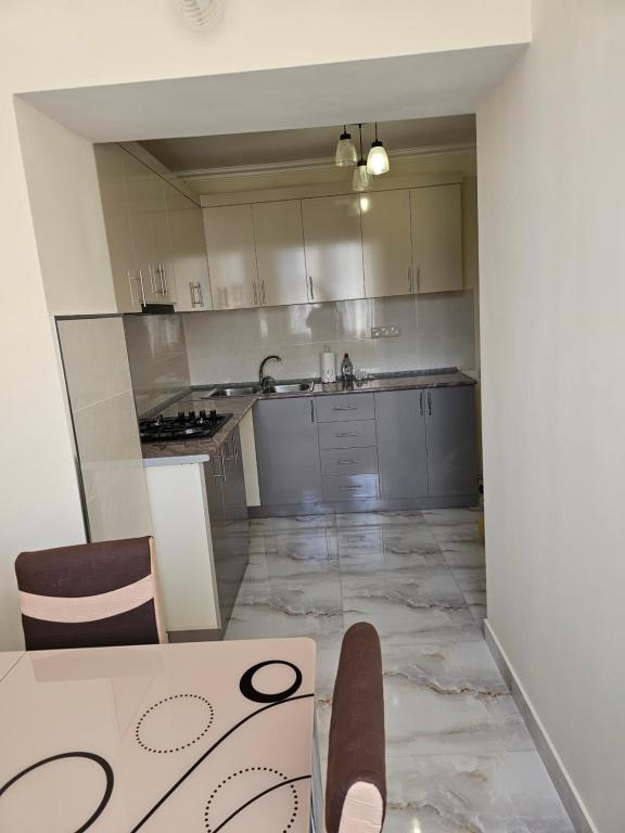 伊杰万Квартира отдыха的厨房配有白色橱柜和桌椅