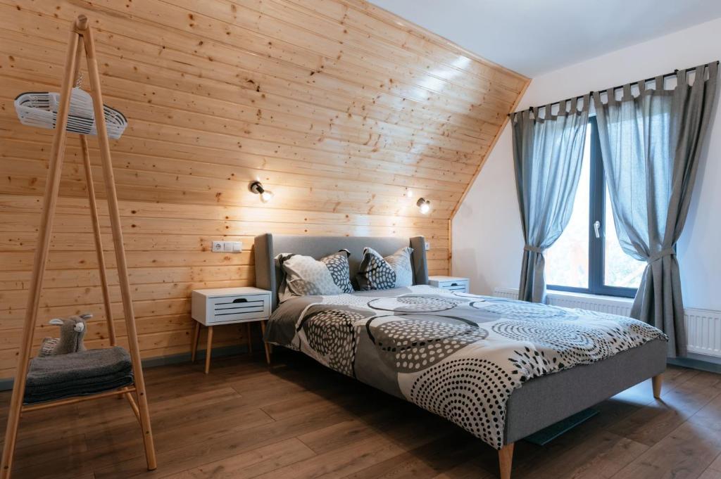 马拉亚Wild Cabin的一间卧室设有木墙和床