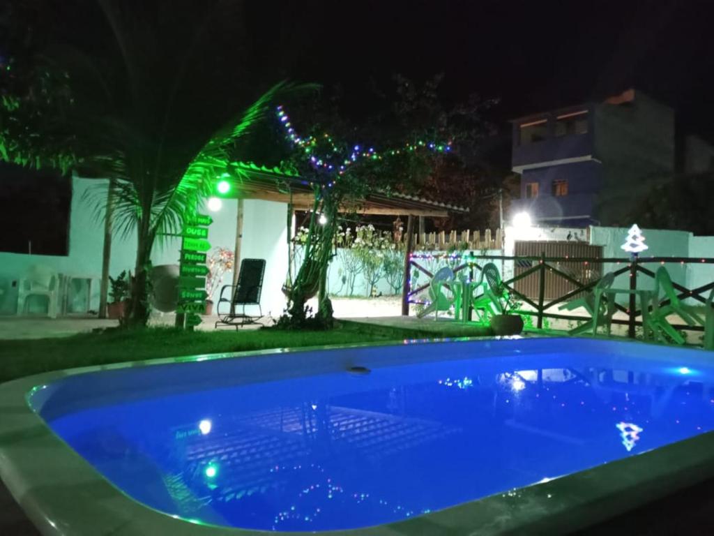 因巴塞Pousada Sol de Imbassai的夜晚在院子里的一个蓝色游泳池