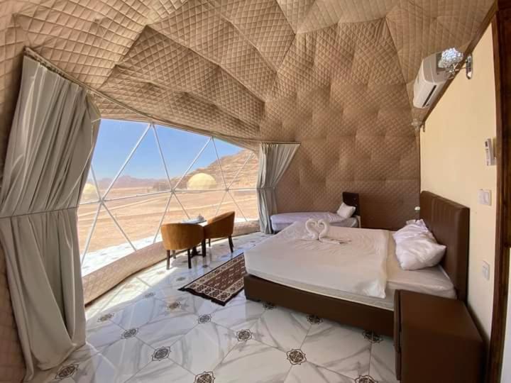 瓦迪拉姆Miral Night Camp的一间带沙发床的卧室,享有沙漠美景
