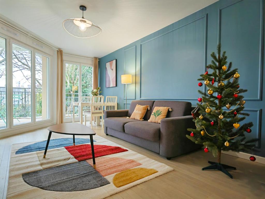 维勒瑞夫Maison de Charme - parking gratuit près de Paris & métro的客厅配有圣诞树和沙发