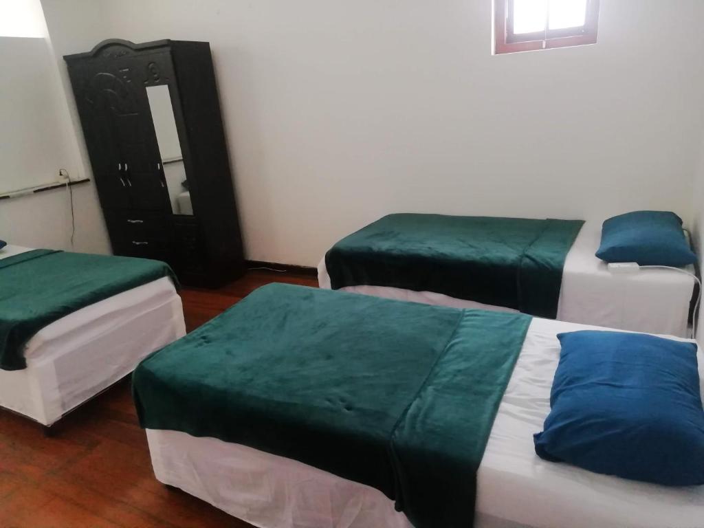 德班PHAKADEHOMES的绿色和白色的客房内的三张床