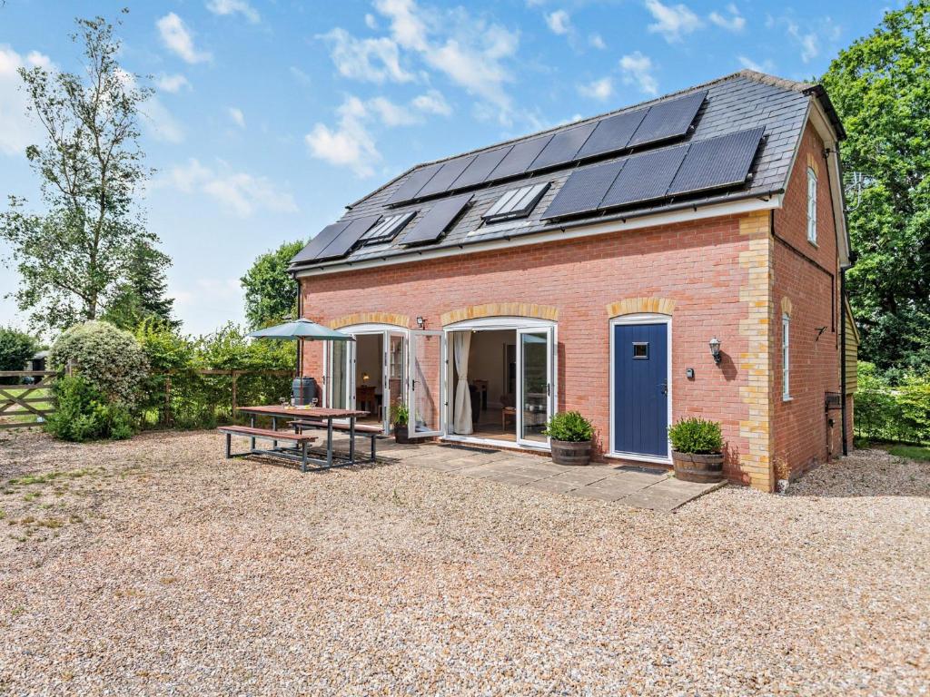 斯特明斯特牛顿3 bed property in Sturminster Newton Dorset RCORN的屋顶上带太阳能电池板的谷仓