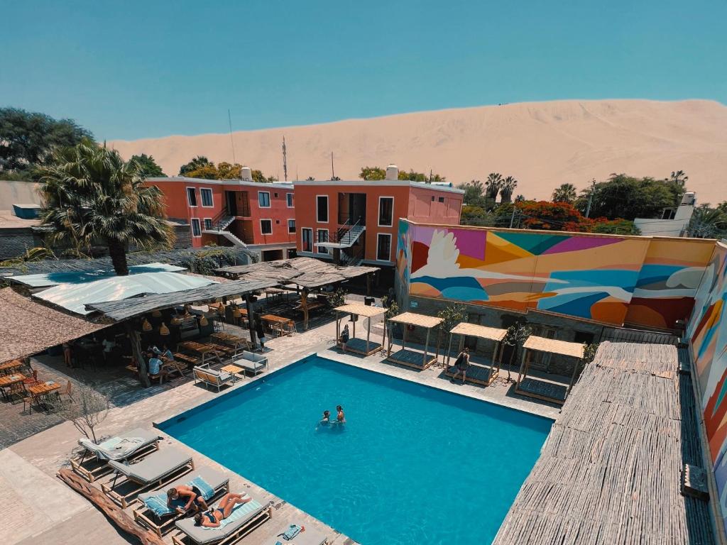 伊察Viajero Kokopelli Huacachina Hostel的沙漠中酒店游泳池的顶部景观