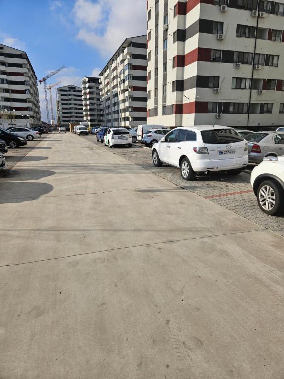 RoşuRobik Studio Militari Residence的停车场的一排停车车