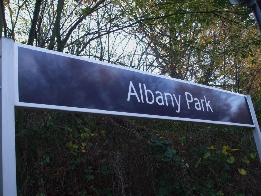 贝克斯利Albany Rooms的树木前的火焰公园街道标志