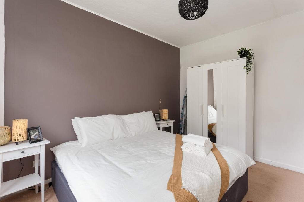 爱丁堡Stunning 2 bed apartment Free Parking的一间卧室配有一张带白色床单和镜子的床