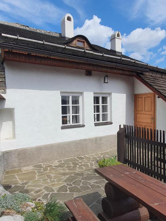 什特兰贝尔克Štramberk V Kútě的前面有长凳的白色房子