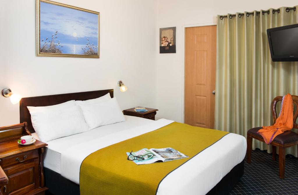 特拉维夫太阳城酒店的一间酒店客房,配有一张床和一台电视