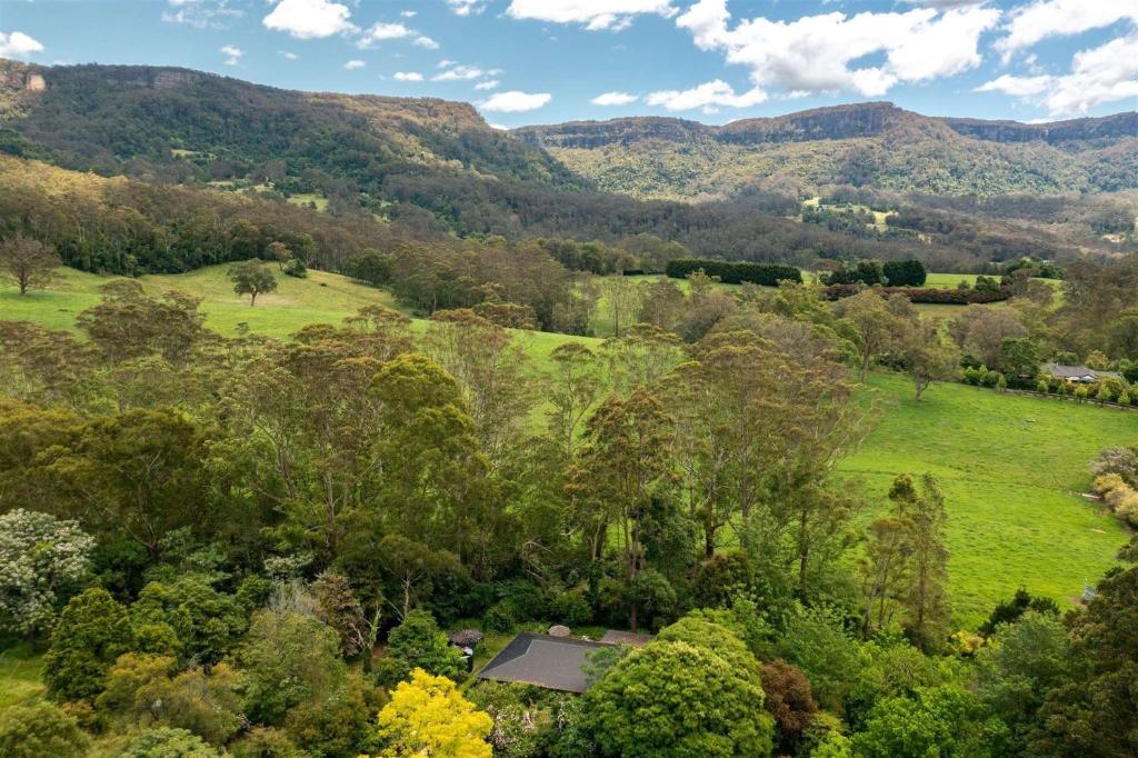 BarrengarryPaddington Cottage, Kangaroo Valley的享有树木和山脉的田野的空中景致