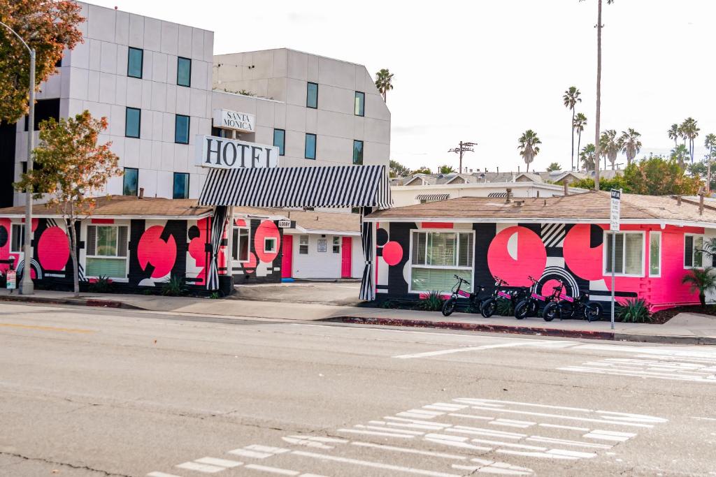 洛杉矶Santa Monica Hotel的街道边的粉红色和白色的酒店