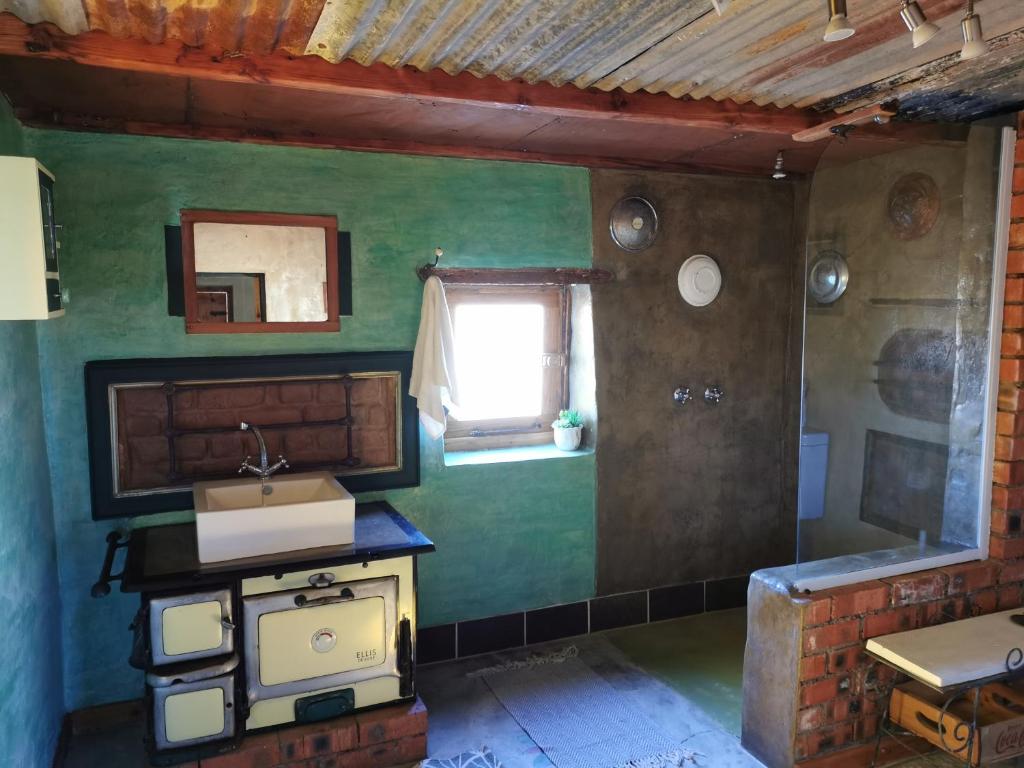 博福特西Silwerkaroo Gastehuis的绿色的客房设有水槽和窗户。