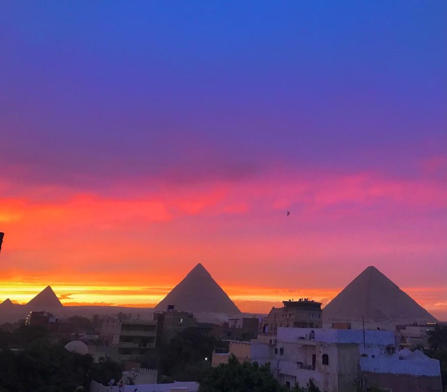 开罗Studio Farida Pyramids View的日落时分吉萨金字塔的景色