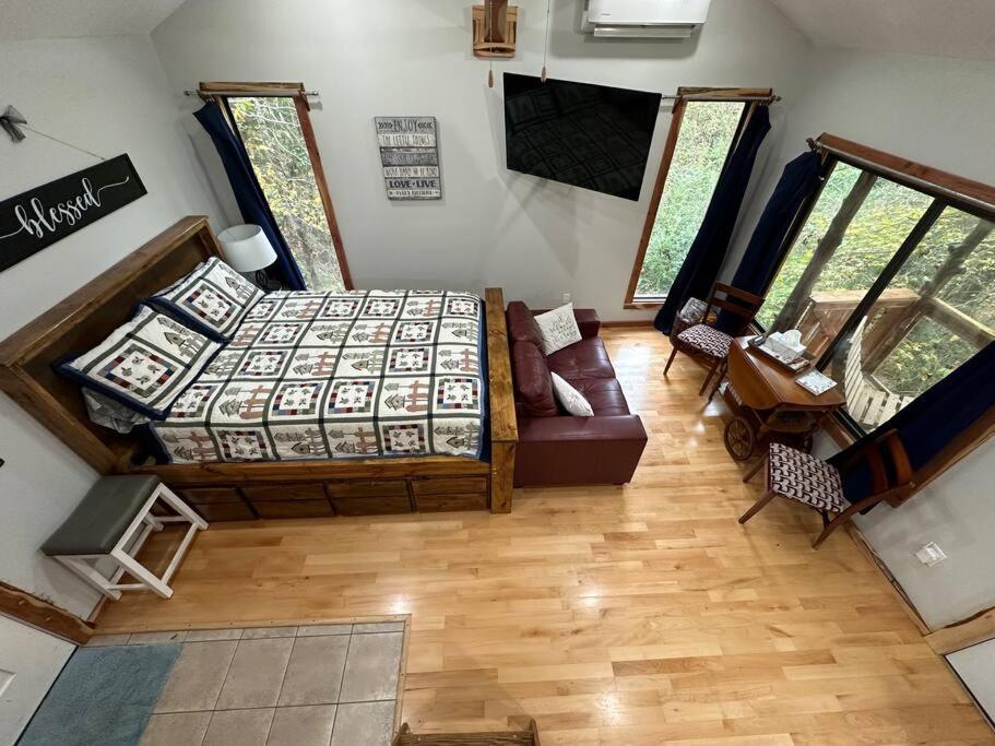 朗维尤Treehouse at Berry-patch的卧室享有上方的景致,配有1张床和1张沙发