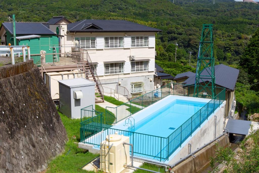 东伊豆町森の風的房屋前有游泳池的房子