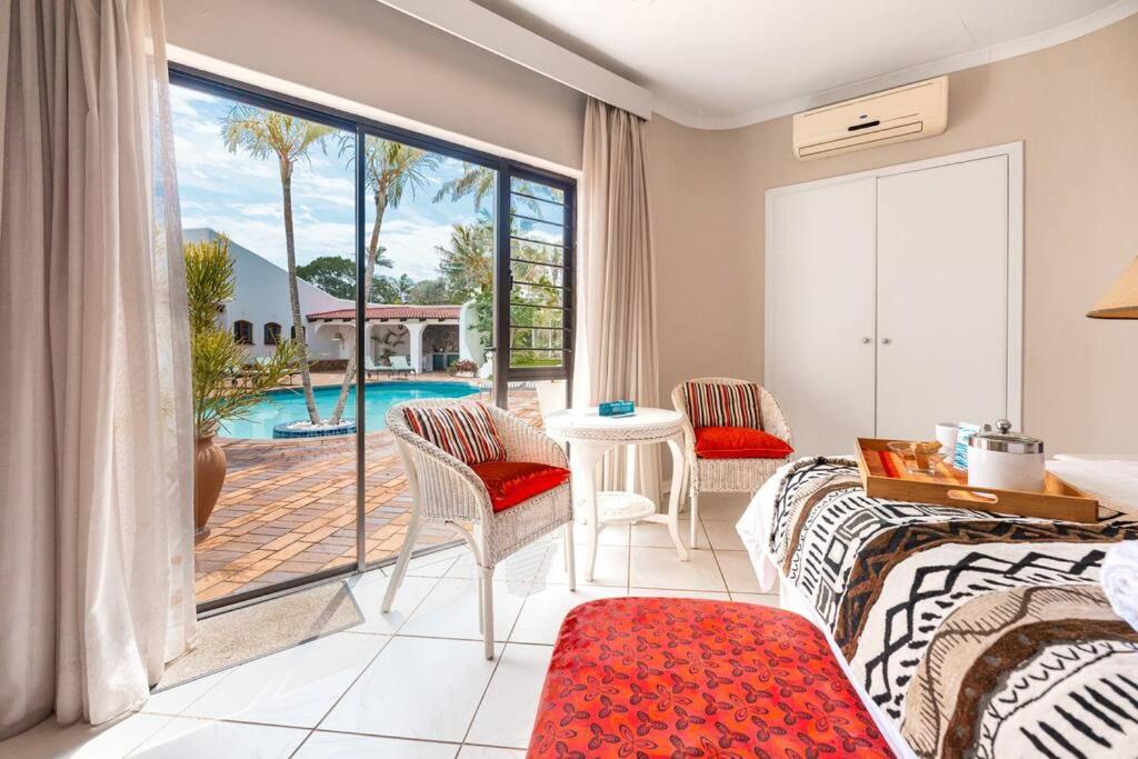 巴利托Lalaria Ocean Villa Suite 4的一间卧室配有一张床,享有游泳池的景色