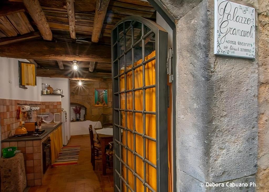 巴尼奥雷焦Palazzo Granaroli的通往带桌子的厨房的开放式门