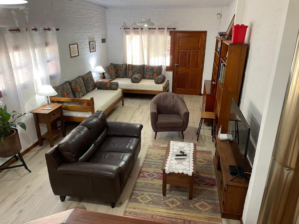 科洛尼亚-德尔萨克拉门托Magnolio的客厅配有黑色真皮沙发和桌子