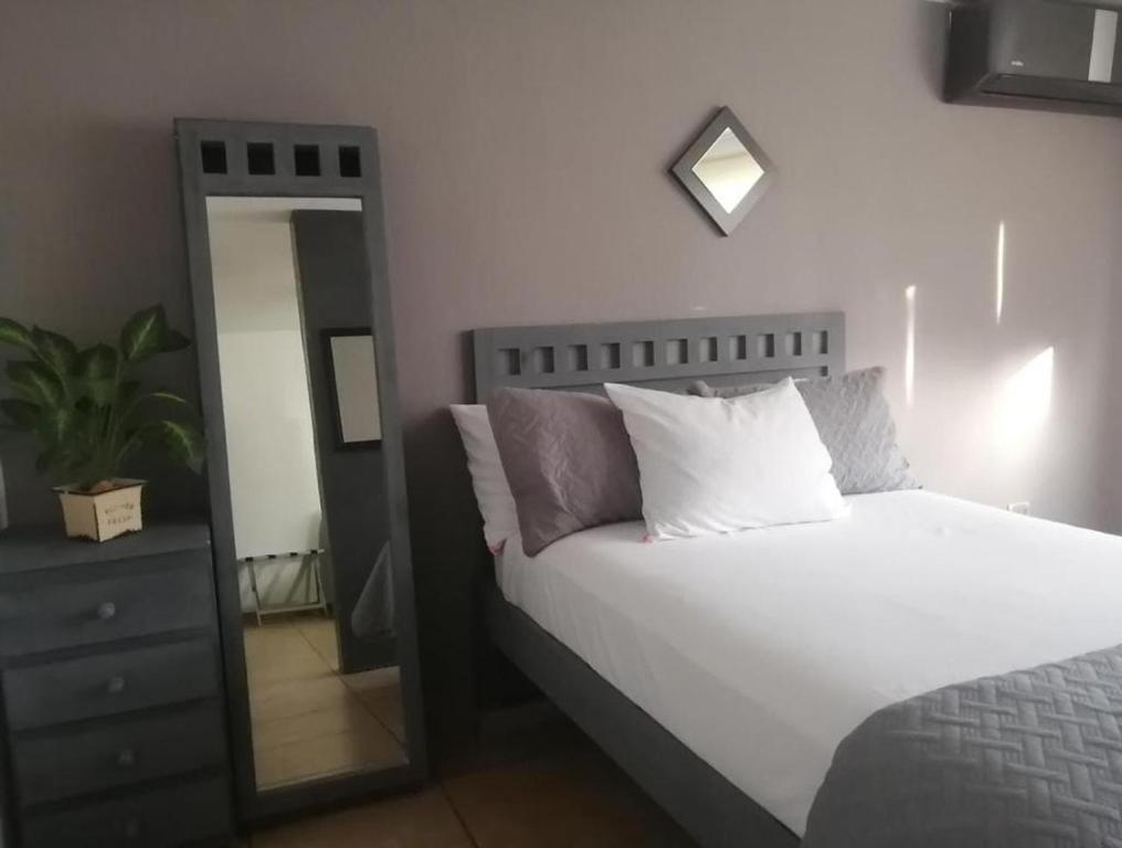 坎昆La Luna的卧室配有白色的床和镜子