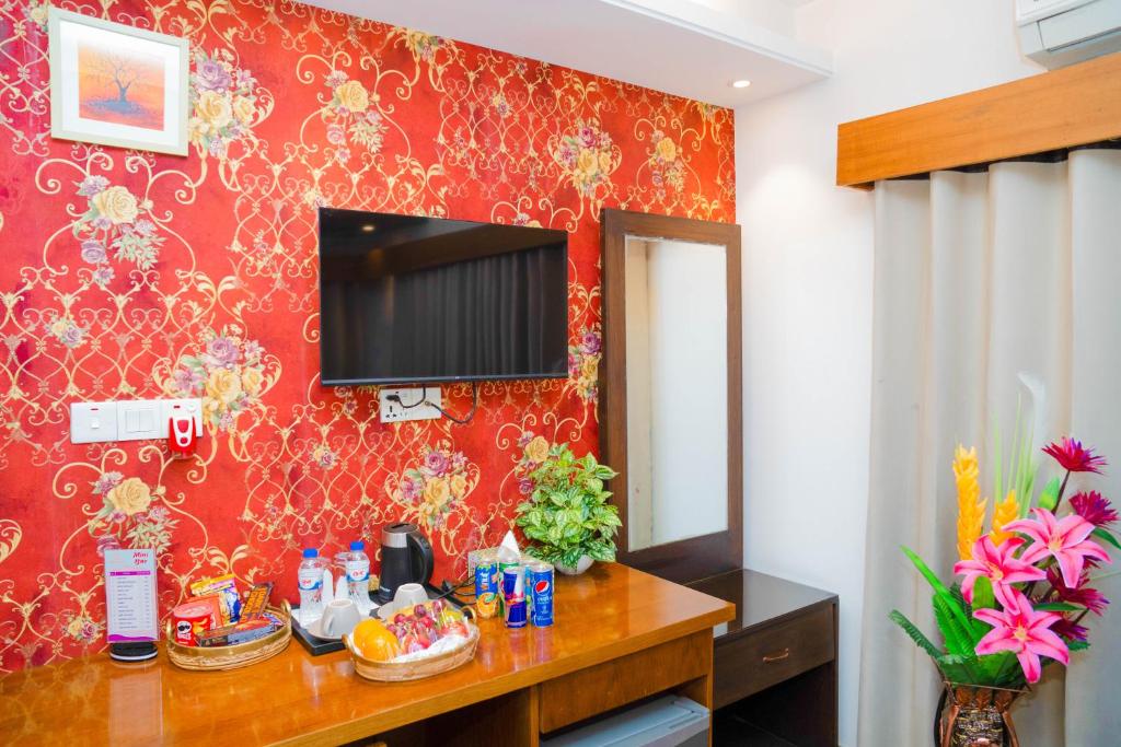 达卡Hotel Air Inn Ltd - Airport View的一间设有一面红色墙壁和镜子的房间