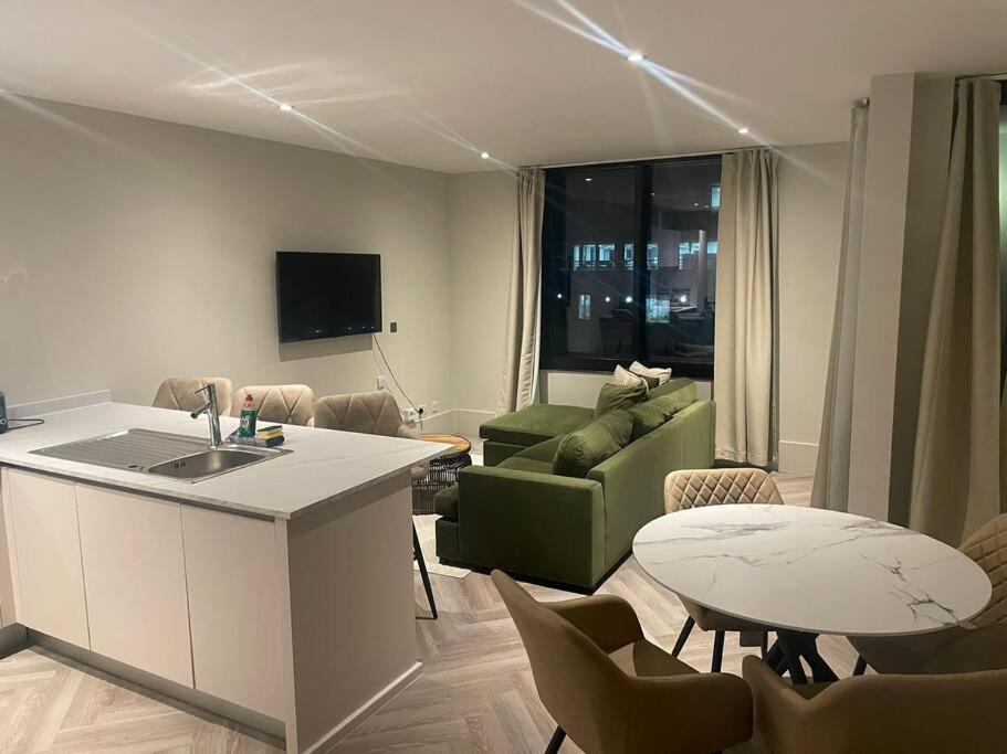 利物浦Luxurious 1 Bed - CITY VIEWS的厨房以及带沙发和桌子的客厅。